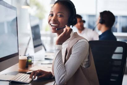 Support professional wearing a headset at an office computer